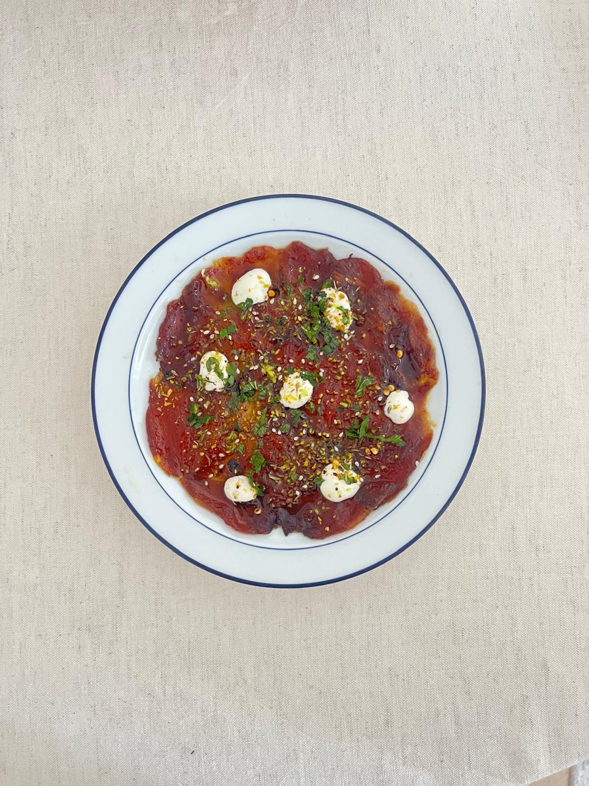 Beef carpaccio starter with herbs and cream