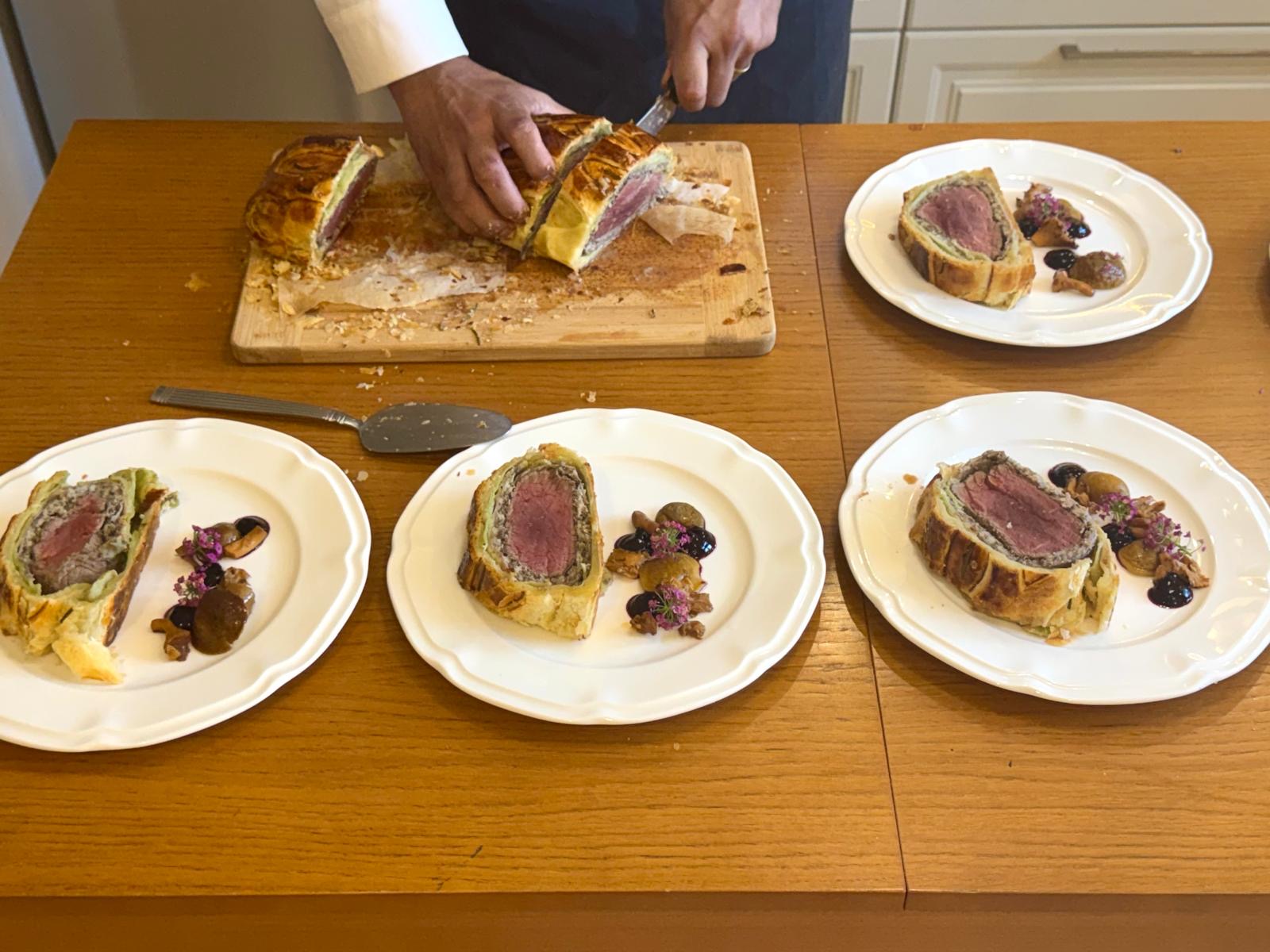 Beef Wellington sliced and plated for a private dinner