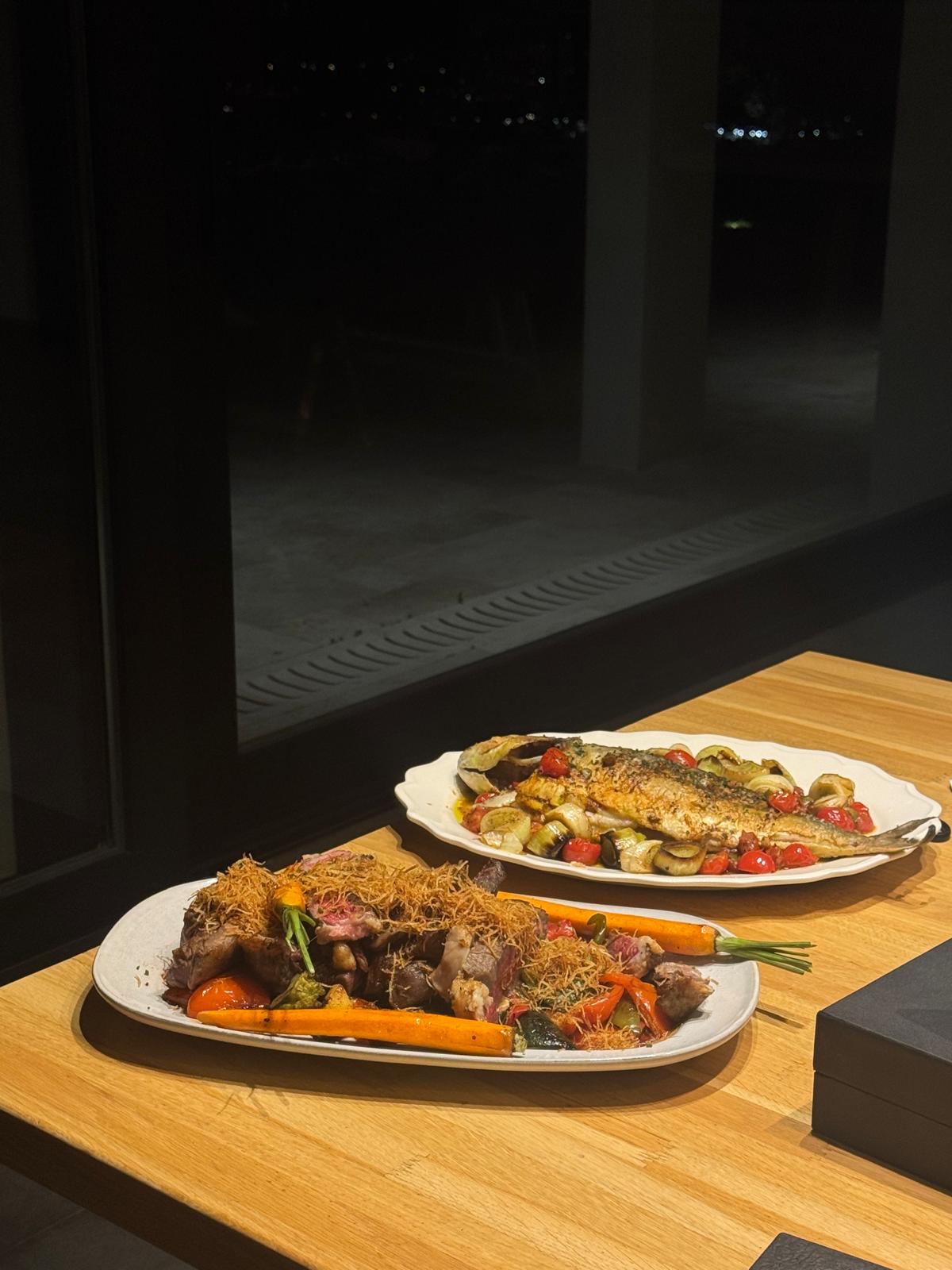 Roast fish and meat served for an evening dinner