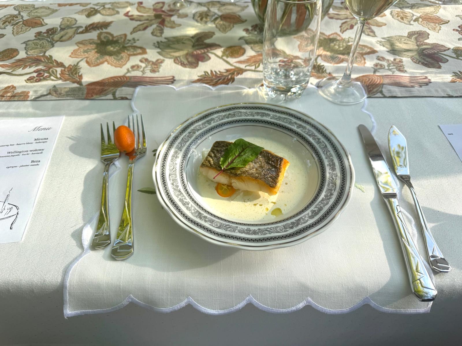 Sea bass served with herbs at a Riviera dinner table