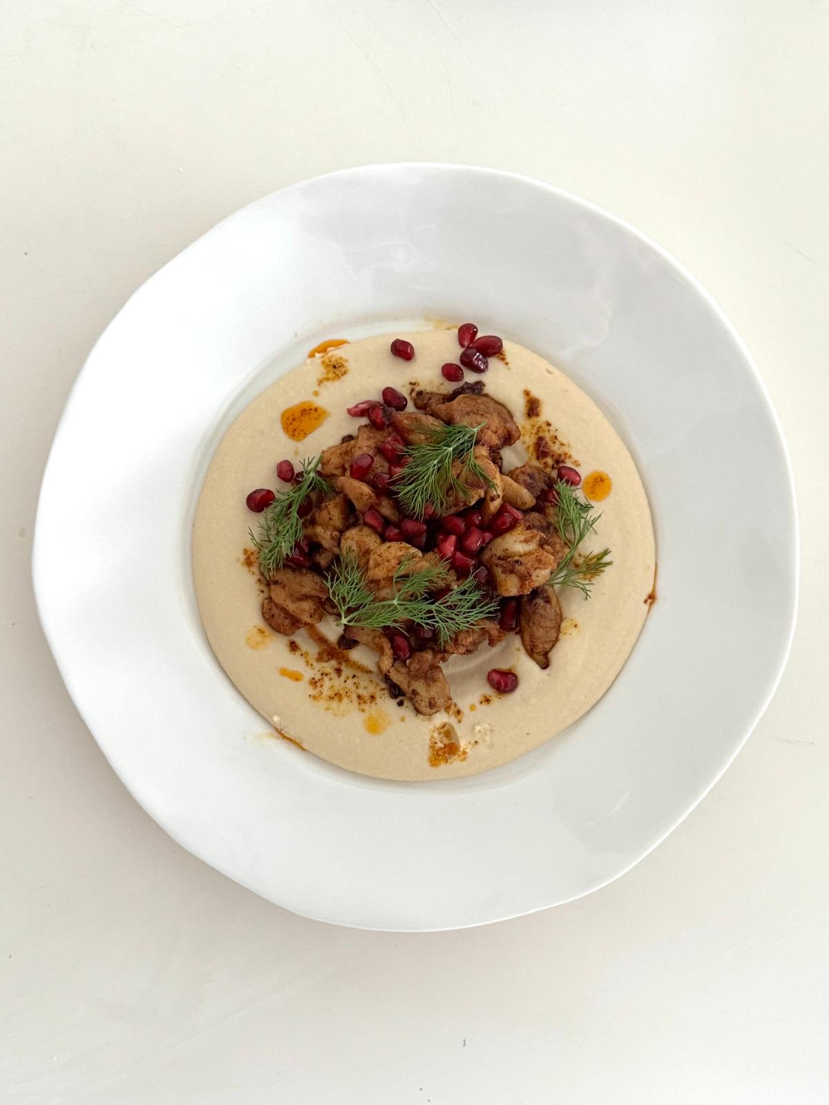Spiced chicken with hummus, pomegranate and fresh herbs